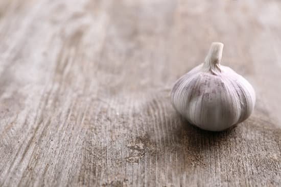 canva fresh garlic on wooden background MAD76plsjG8