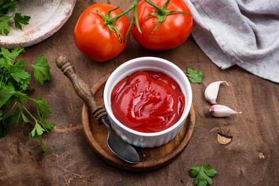 canva fresh homemade tomato sauce with garlic on wooden background MAD95G UTK4