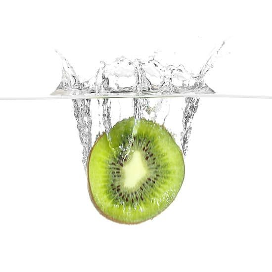 canva fresh kiwi falling in water isolated on white MAD QztSZ9s