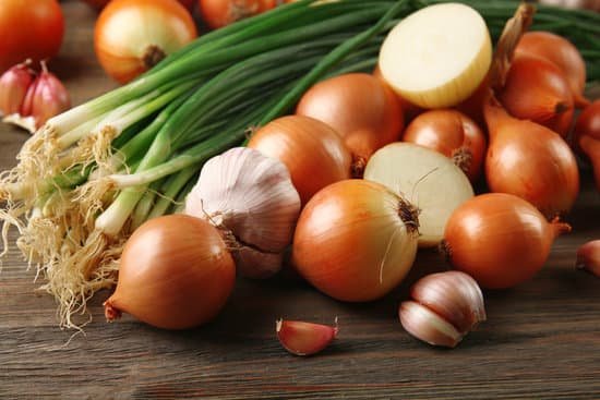 canva fresh onions with garlic on wooden background MAD M9crgZo