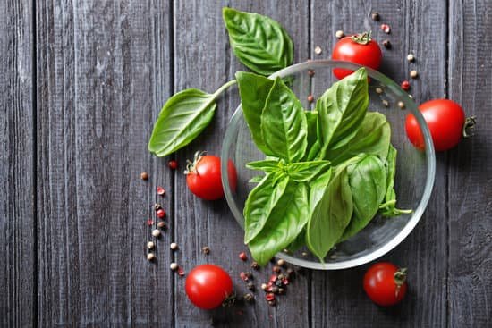 canva fresh organic basil and cherry tomatoes on wooden background MAD9T1sIkVs