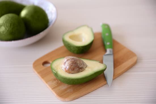 canva fresh sliced avocado on cutting board MAD QoDBsfY