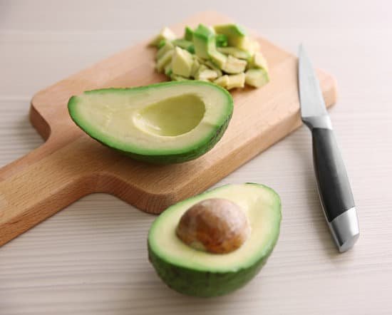canva fresh sliced avocado on cutting board MAD QvojXlY
