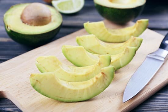 canva fresh sliced avocado on cutting board close up MAD QoeYg8A