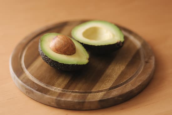 canva fresh sliced avocado on wooden board. MAERFS4Q4 4