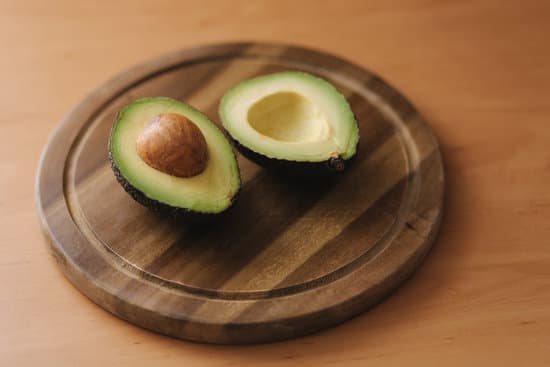 canva fresh sliced avocado on wooden board. MAERFcdKrSQ