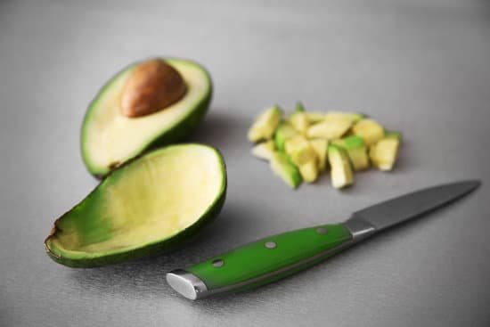 canva fresh sliced avocado with knife on table MAD