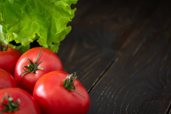 canva fresh tomatoes and lettuce on a wooden table MAERCkpgG5M