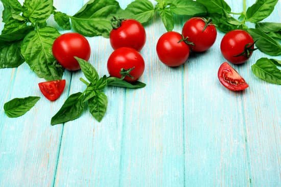 canva fresh tomatoes with basil on wooden table MAD MfHHmMk