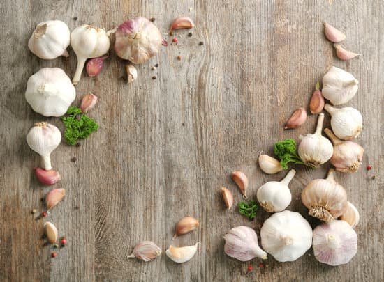 canva fresh whole garlic and cloves on wooden background MAD76vUdRJM