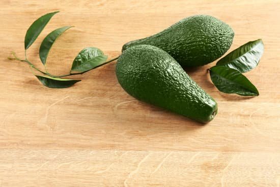 canva fresh whole green avocados on wooden table MAD QhXWq2Y