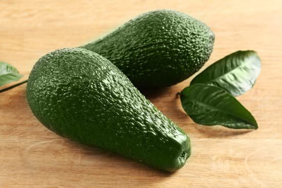 canva fresh whole green avocados on wooden table MAD Qiwgv Q
