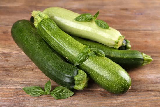 canva fresh zucchini and basil on wooden table close up MAD MRSPP3E