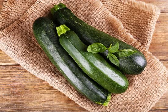 canva fresh zucchini with basil in sackcloth on wooden table MAD MQM0vKo