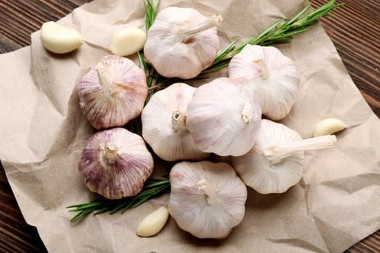 canva garlic and rosemary on a wooden table MAD 70Y0wW8