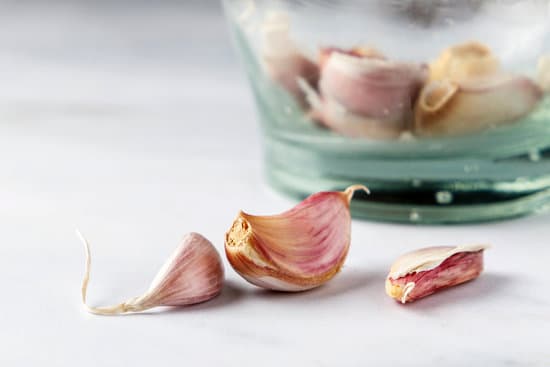 canva garlic cloves on a glass container MAEkzrlIeLU