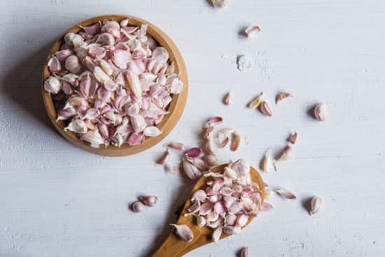 canva garlic cloves on wooden bowl and spoon top view MAEH3Cn3BBU