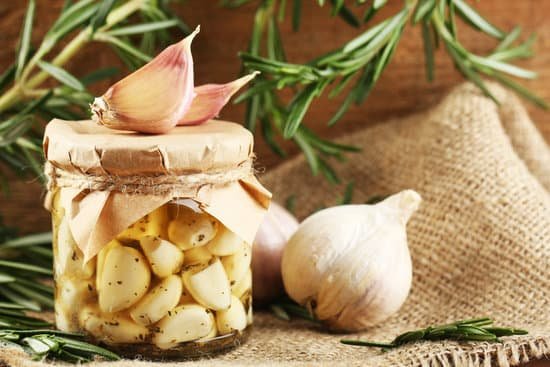 canva garlic in glass jar on wooden background MAD ML HmO4