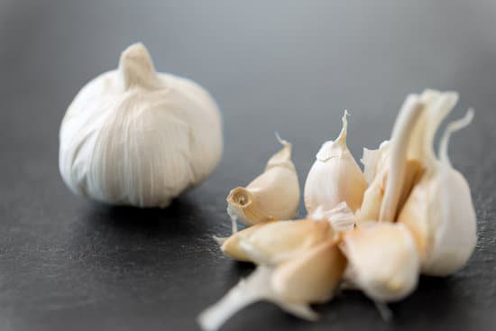 canva garlic on slate stone background MAEQQu2i8nI