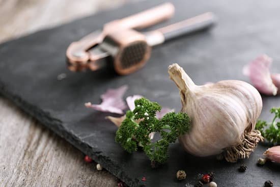 canva garlic with herbs and spices on slate plate MAD76lJOHiA