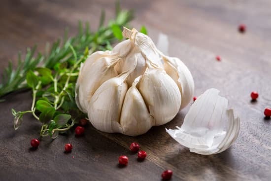 canva garlic with red pepper and herbs on a wooden table MAEN5f0WEzI