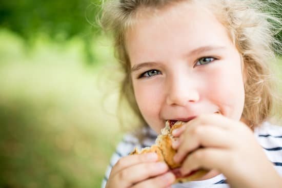 canva girl eating snack at the park in summer MACaKoOeRDY