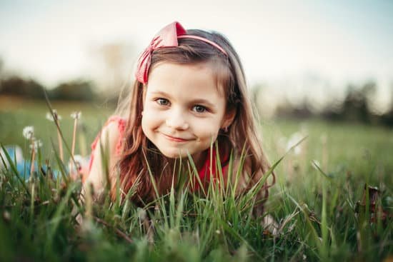 canva girl lying on grass among dandelions MAD 0r0 nvY