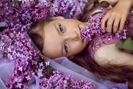 canva girl lying on the ground with lilacs