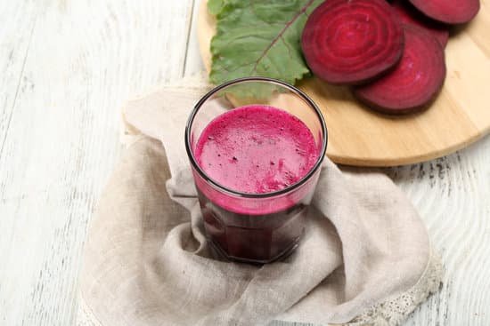 canva glass of beet juice with vegetables on table MAD MYQL064