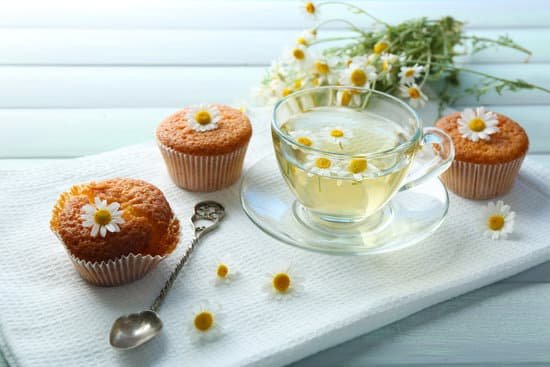 canva glass of chamomile tea with chamomile flowers and tasty muffins MAD MYQu 7E
