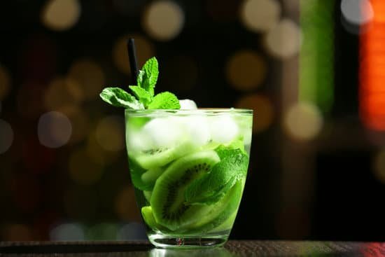 canva glass of cocktail with kiwi and mint on table MAD