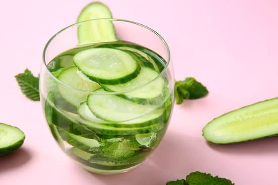 canva glass of cucumber infused water on a pink table MAD7FQVFOh0