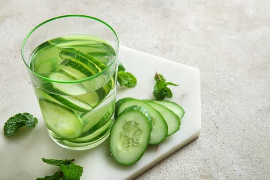 canva glass of cucumber infused water on a table MAD7FQ143d0