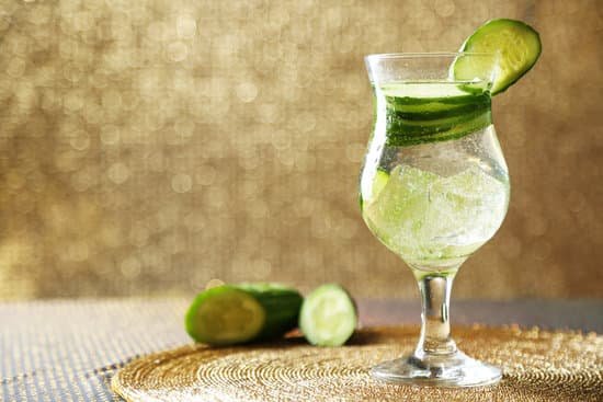 canva glass of water with cucumber on light background MAD MRJU1XQ