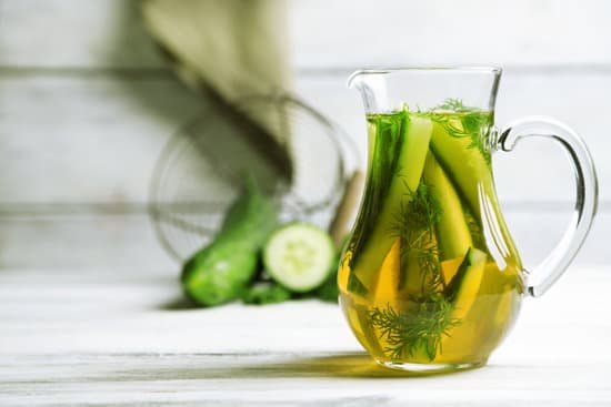 canva glass pitcher with fresh cucumber and rosemary infused water MAD MNAM4po