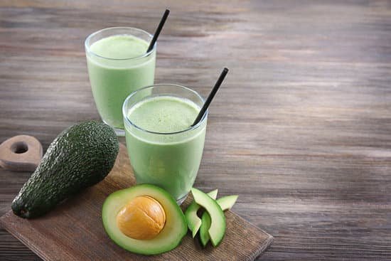 canva glasses of avocado smoothie on wooden table MAD Qs0sbY4