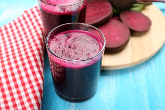 canva glasses of beet juice on color wooden table MAD MRPyy4c