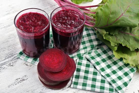 canva glasses of beet juice with beets on a wooden table MAD MYL8M74
