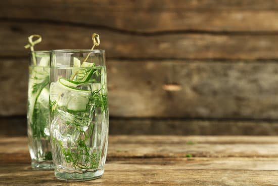 canva glasses with fresh organic cucumber water on a table MAD MO4okWY
