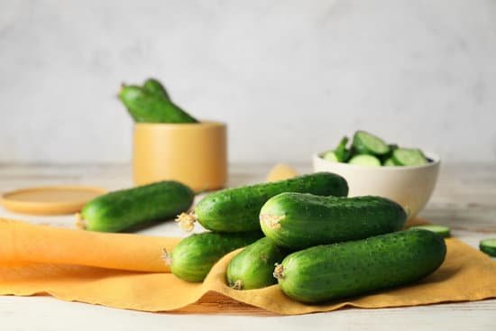 canva green cucumbers on wooden table MAD6rKk68Ns