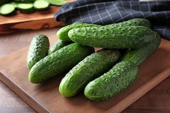 canva green fresh cucumbers on wooden board MAD9bjsLl9I