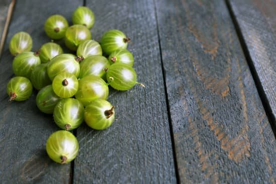 canva green gooseberry on wooden background MAD MXqJY1M