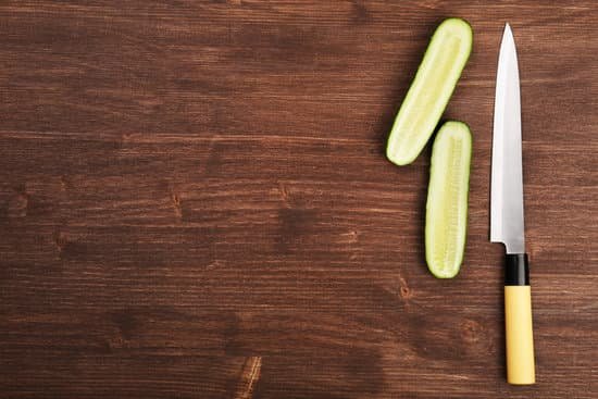 canva halves of cucumber with knife on wooden background MAD MRtANYE