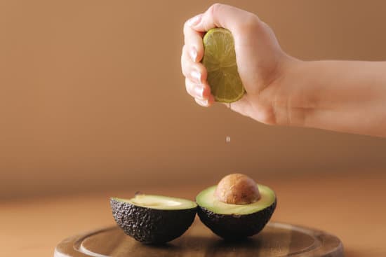 canva hand squeezing lime juice on avocado MAERFYJ39vI