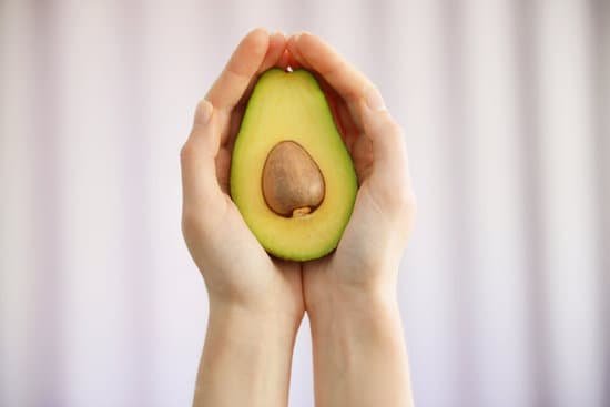 canva hands holding fresh avocado closeup MAD QvdBZeg