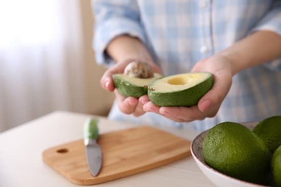 canva hands holding fresh avocado closeup in kitchen MAD Qosn2NA