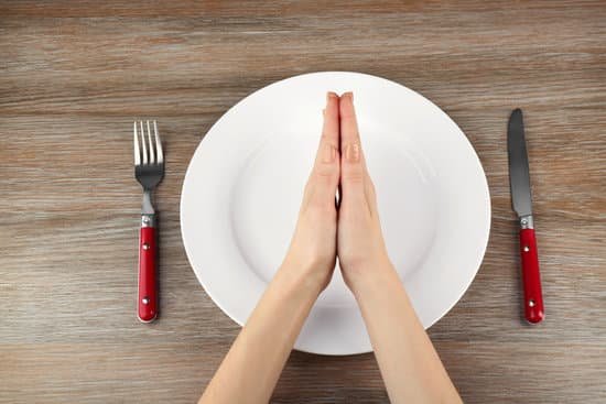 canva hands in praying position over an empty plate MAD QtG J9c