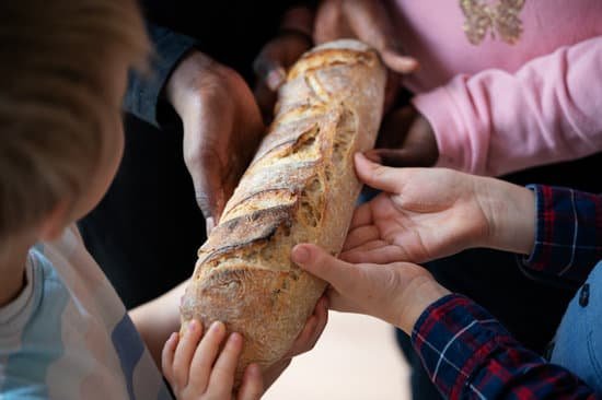 canva hands of four children black and white holding one loaf of br MAD5lbvYCtE