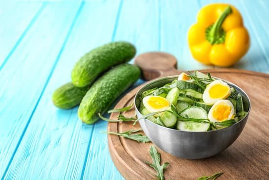 canva healthy salad with cucumbers and eggs in bowl on table MAD9TxY dh0