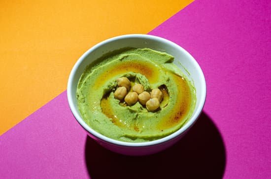 canva homemade avocado and chickpea hummus in a bowl MAD sq577mw